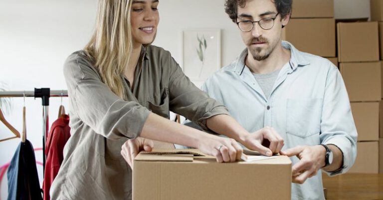 Packing Light - Woman Putting the Sticker on the Box