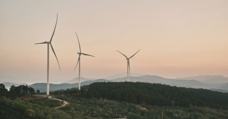 Sustainable Trails - Landscape with Wind Turbines and Mist