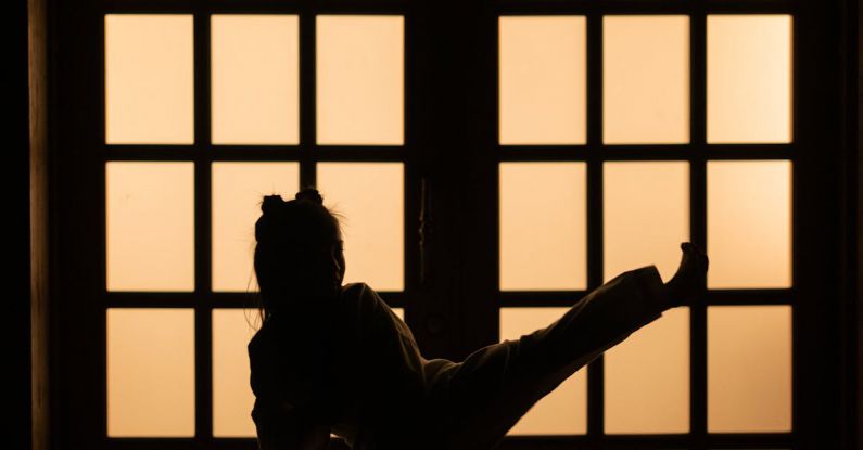 Indoor Training - Silhouette of Man Standing on Window