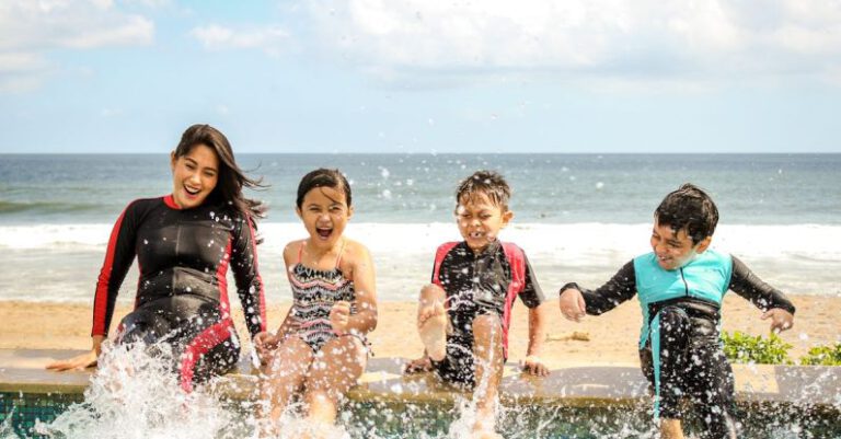 Family Vacation - Woman and Three Children Playing Water