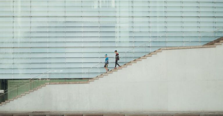 Descending - Two People Descending the Stairs