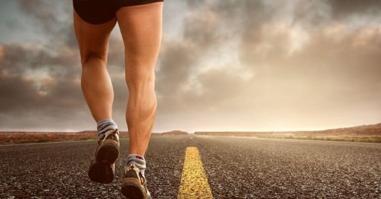 Endurance - Low Angle Photography Man Walking on Asphalt Road