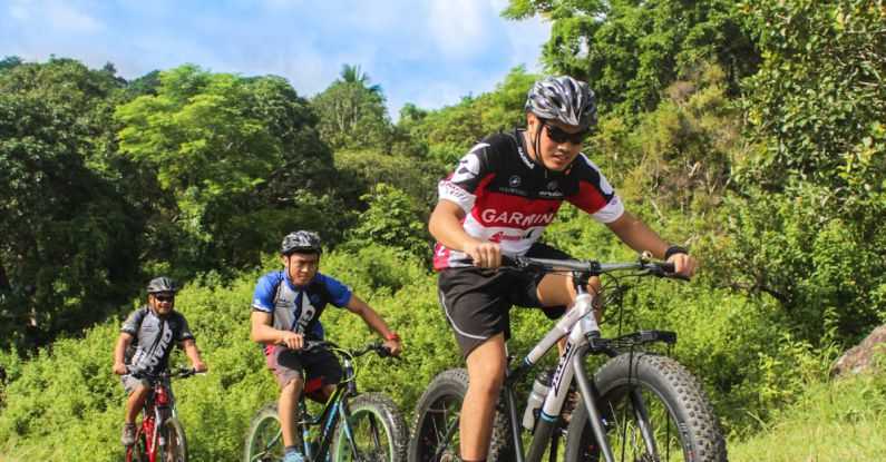 Group Riding - Three Men Riding on Bicycles