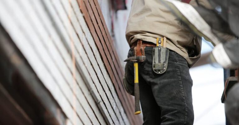 Maintenance - Man Wearing Black Denim Pants With Carrying Hammer on Holster