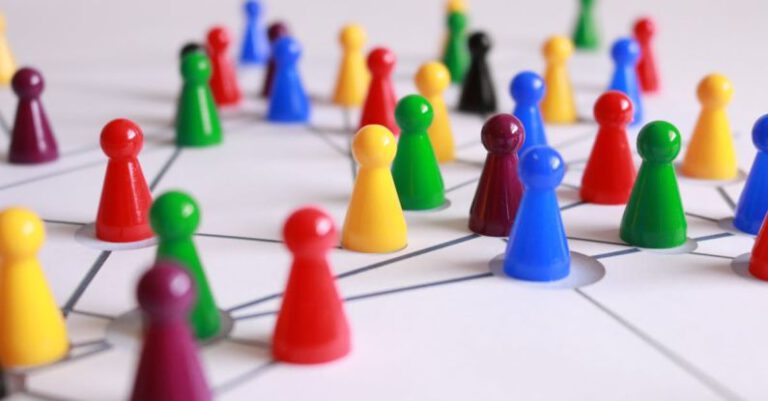 Strategies - Close Up Photography of Yellow Green Red and Brown Plastic Cones on White Lined Surface