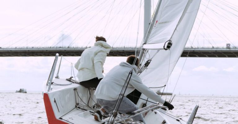 Racing Team - Man in White Shirt Sitting on Red and White Boat