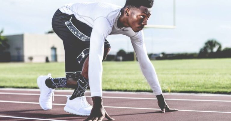 Sprinting - Man Wearing White Sweater and Black Shorts About to Run