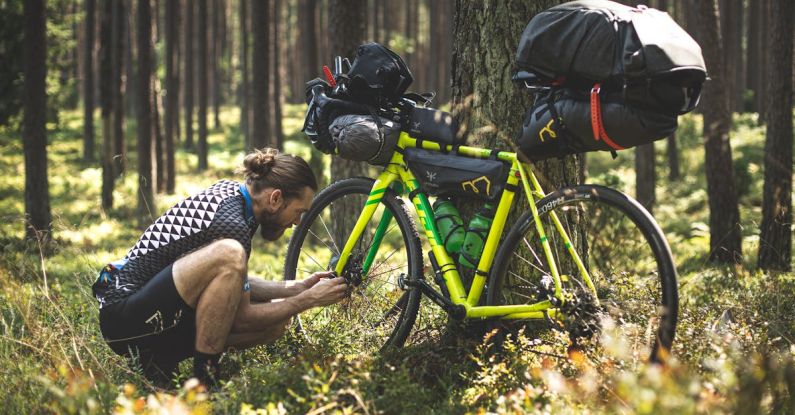 Bikepacking - A Man Fixing His Bicycle